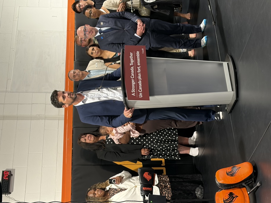 Canada’s Justice Minister Sean Fraser speaking at a podium during a youth crime prevention funding announcement in an Edmonton boxing gym